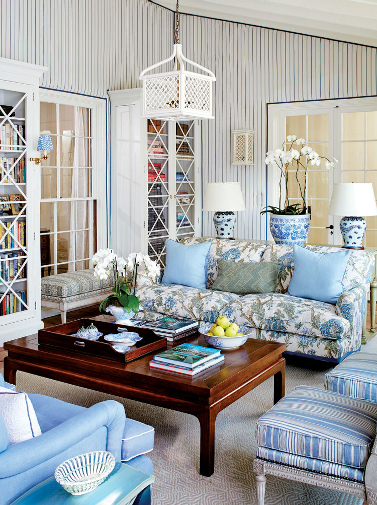 Blue and white living room with patterned sofa, striped blue and white wallpaper and classic decor