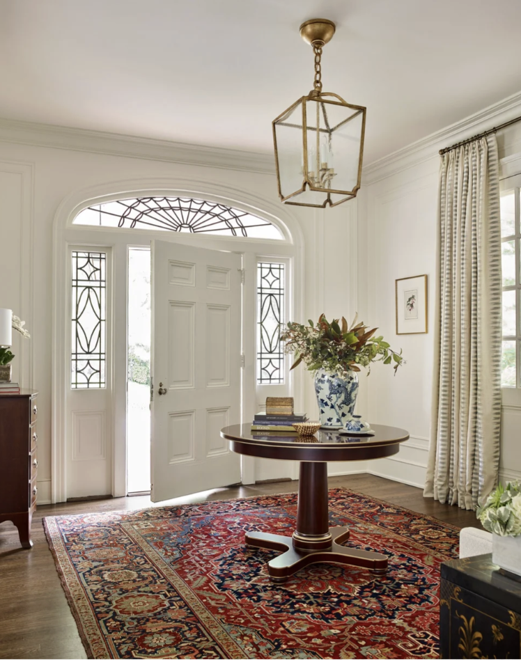 Interior Designer: Jessica Bradley Interiors | Architect: Frank Neely | Builder: Davey Construction | Photographer: Emily Followill | Classic home design ideas for a beautiful foyer. Love the round table and oriental rug with a lantern above the table