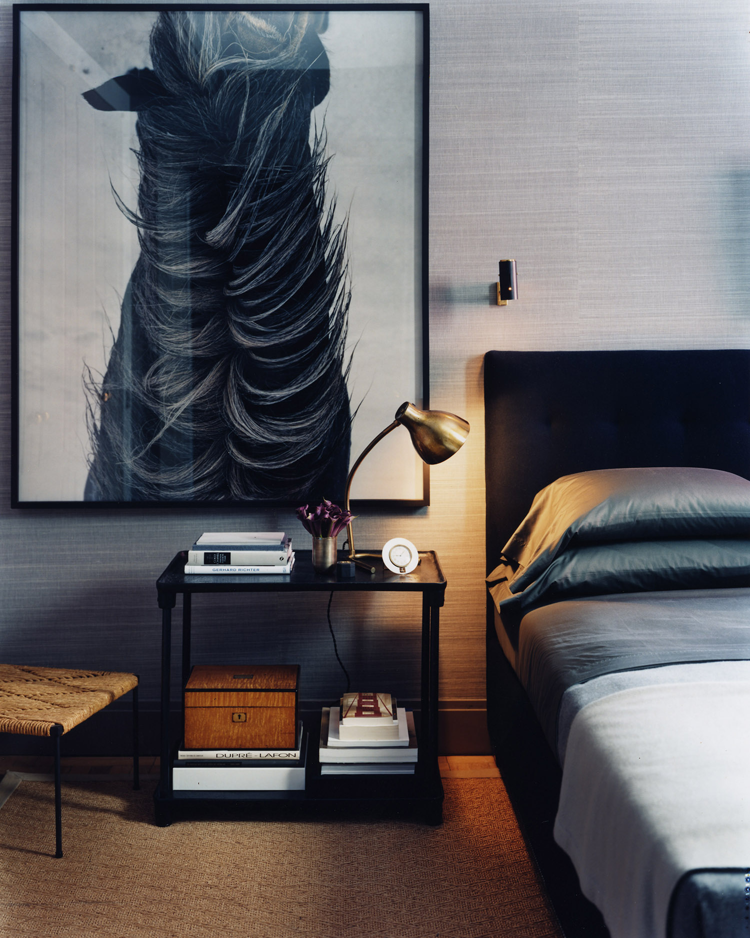 Primary bedroom with black furniture a large horse print, and a collected home look
