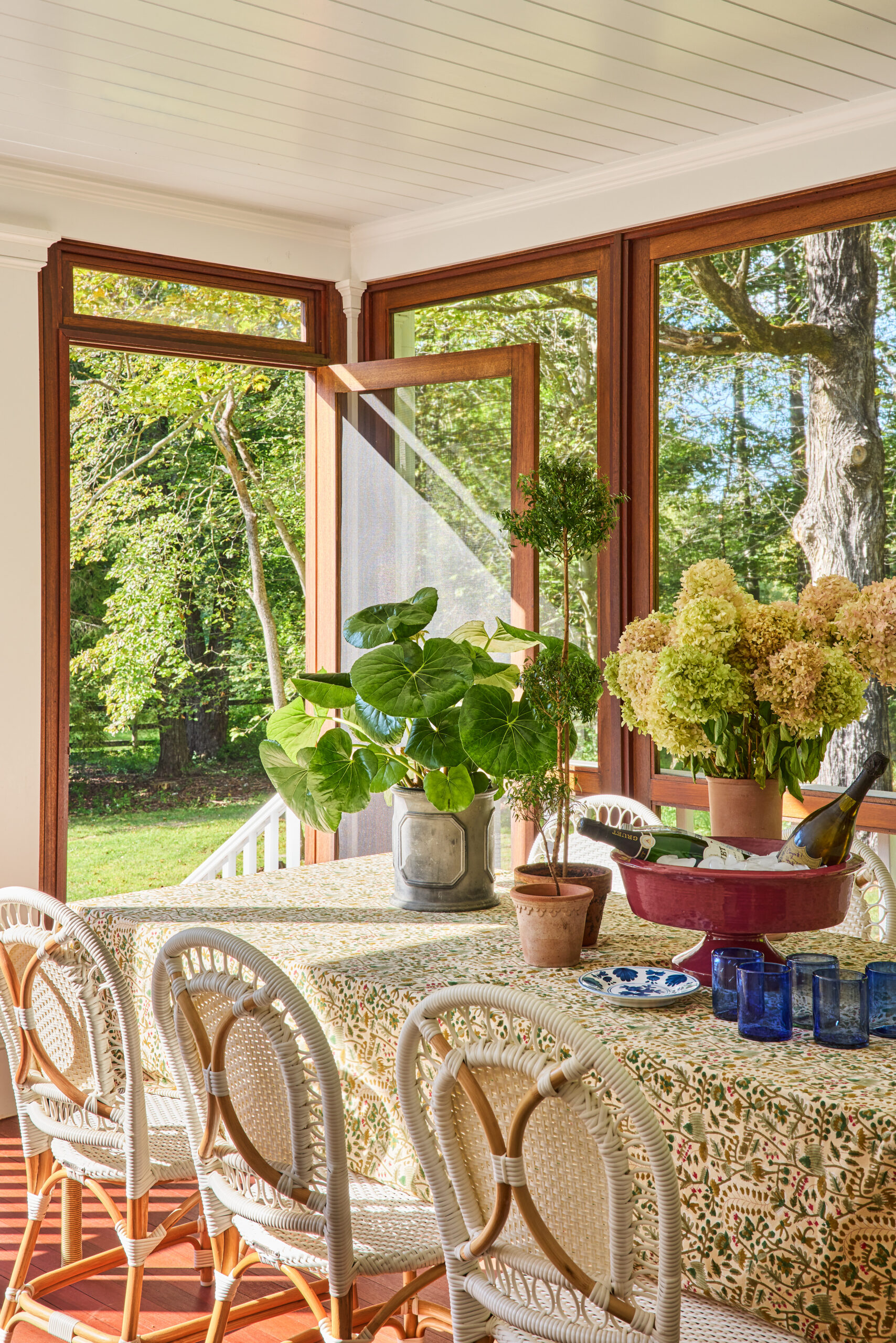 Hunter creates perfect spaces in this timeless Bedford home and has us teeming with inspiration.  Covered porch with a charming green and white tablecloth