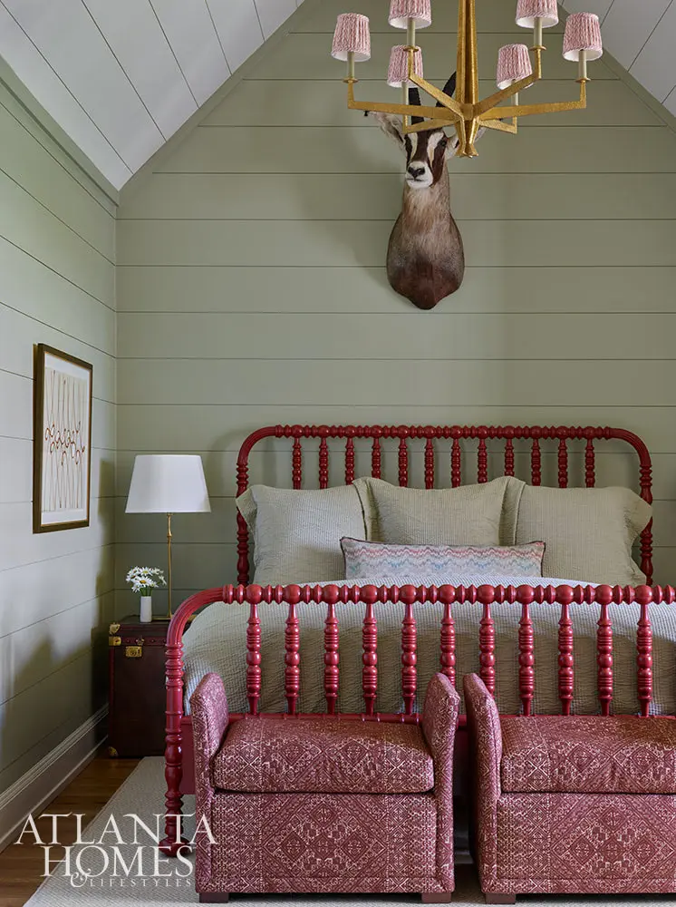 In the spirit of that, this fabulous mountain retreat is the perfect place to spend a summer day–and a great place to curl up by the fire come fall. Charming bedroom with red spindle bed