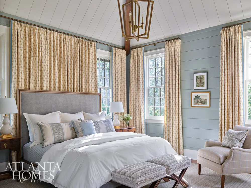 primary bedroom with blue shiplap walls and blue and white bedding