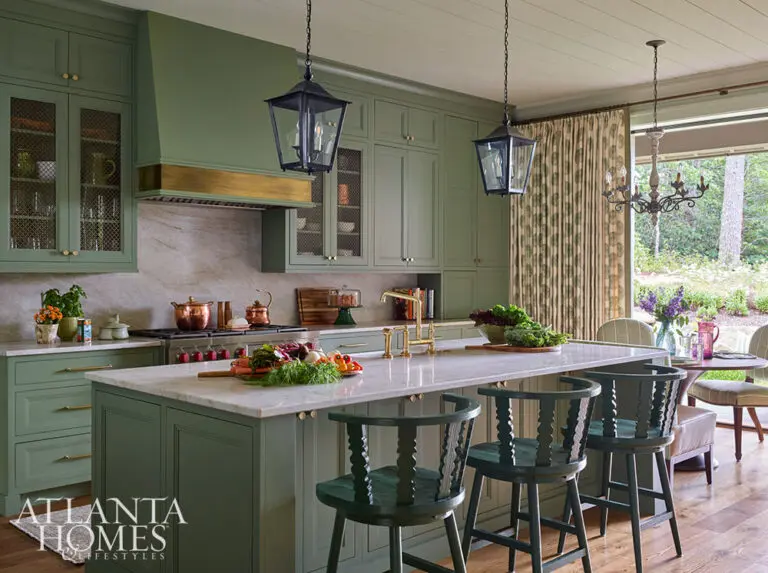In the spirit of that, this fabulous mountain retreat is the perfect place to spend a summer day–and a great place to curl up by the fire come fall. Green kitchen with hanging lanterns