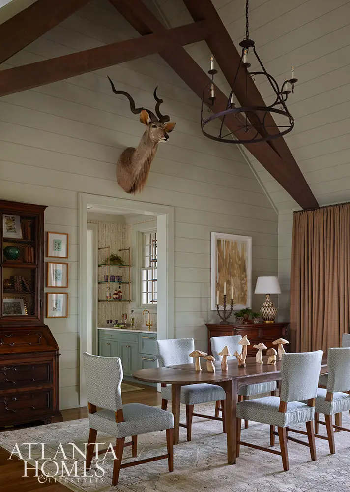 In the spirit of that, this fabulous mountain retreat is the perfect place to spend a summer day–and a great place to curl up by the fire come fall. - Beautiful dining room with oveal dining table and deer taxidermy