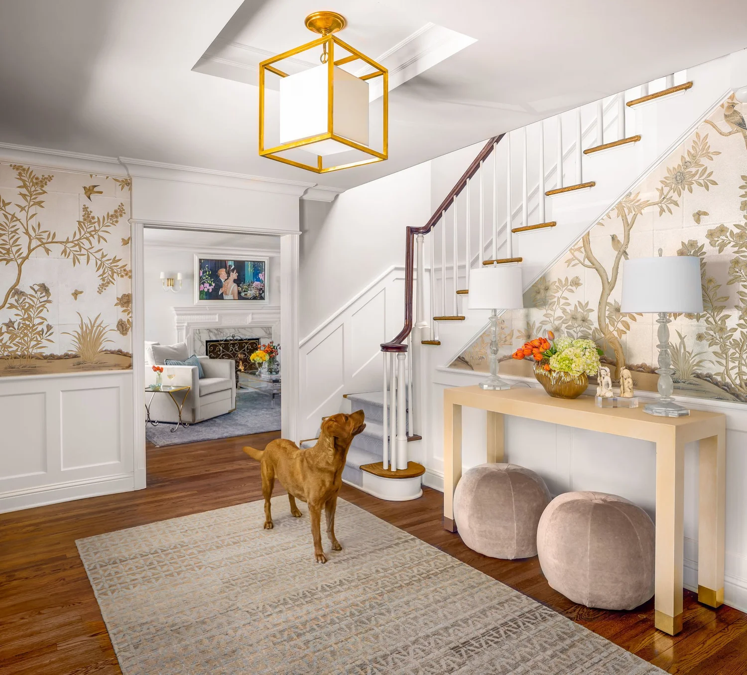 this beautiful foyer with neutral wallpaper with a console table is creating a Timeless home design