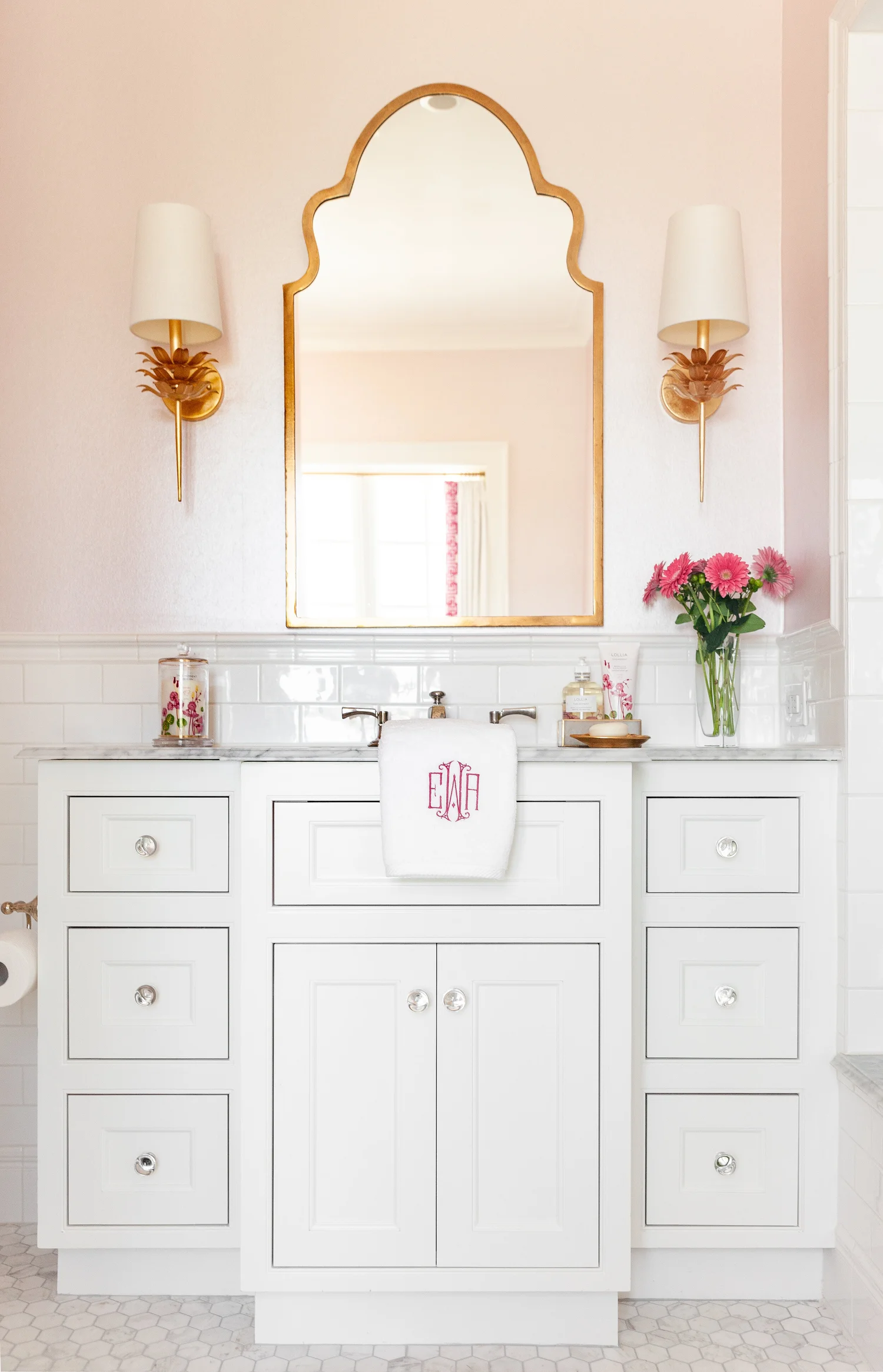 Beautiful bathroom with white cabinets and monogrammed towels