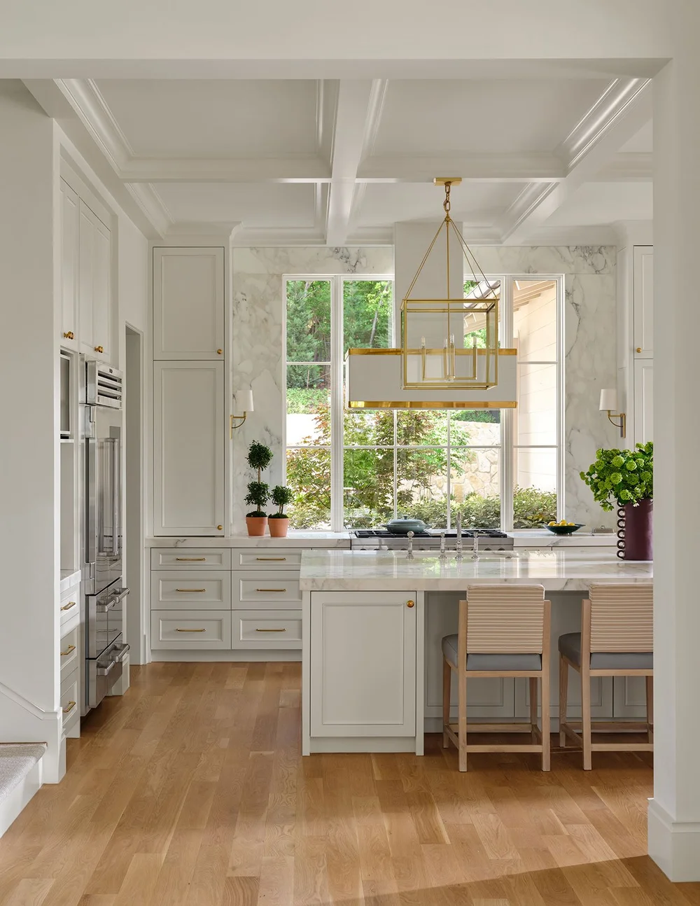 SHM Architects | Mary Beth Wagner Interior Design| Nathan Schroder Photography white kitchen with brass hardwareDesigned by Mary Beth Wagner,this place is the perfect mix of traditional touches and updated details, well-suited for family, entertaining and more.