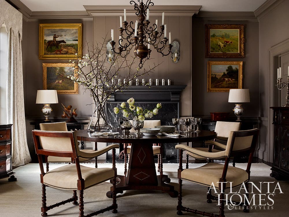Traditional dining room with round table and beautiful oil landscape paintings