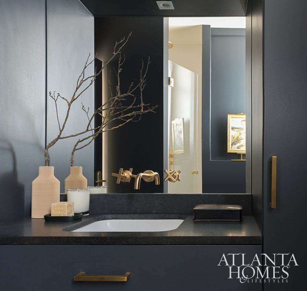 Paris is always a good idea, and when Ann Huff of Huff Harrington is designing your home, it's an even better one! Moody blue bathroom with brass hardware - Source: Atlanta Homes & Lifestyles | Interior Design: Ann Huff, Huff Harrington |  Photographed by Joan Porcel