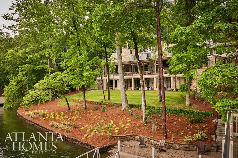 • Lakeside view of the back of the house showing beautiful custom landscaping running right to the water's edge