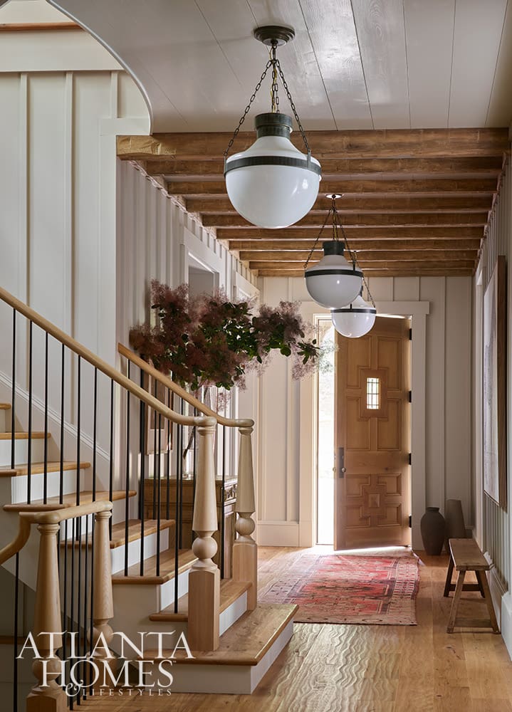 • Visual Comfort Modern Schoolhouse Lanterns in a classic wood beamed entry at the Lake Burton retreat