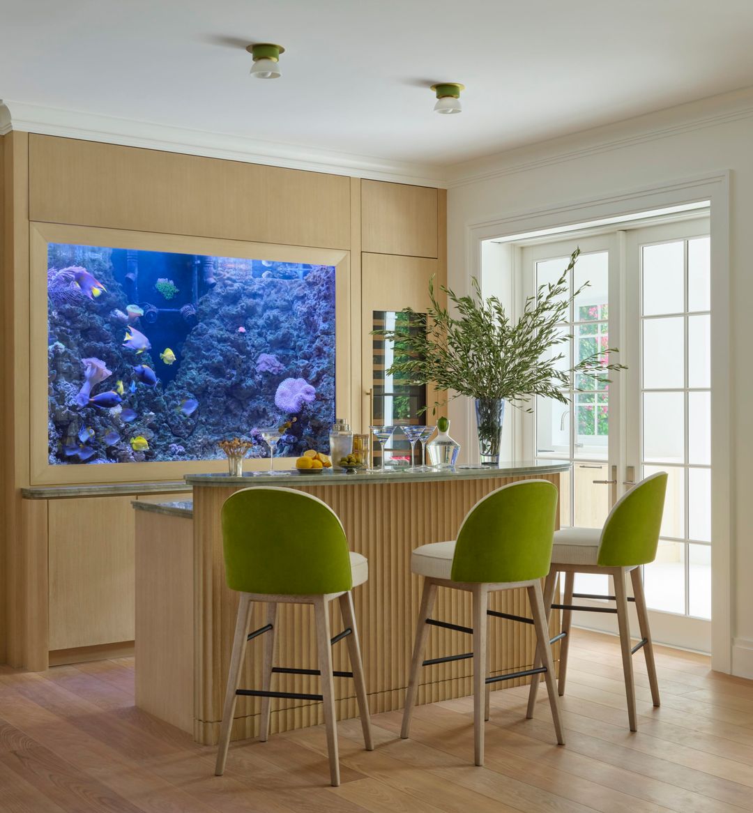 Wood bar with green stools and an aquarium - Caitlin Kah Interior Design | Brantley Photography