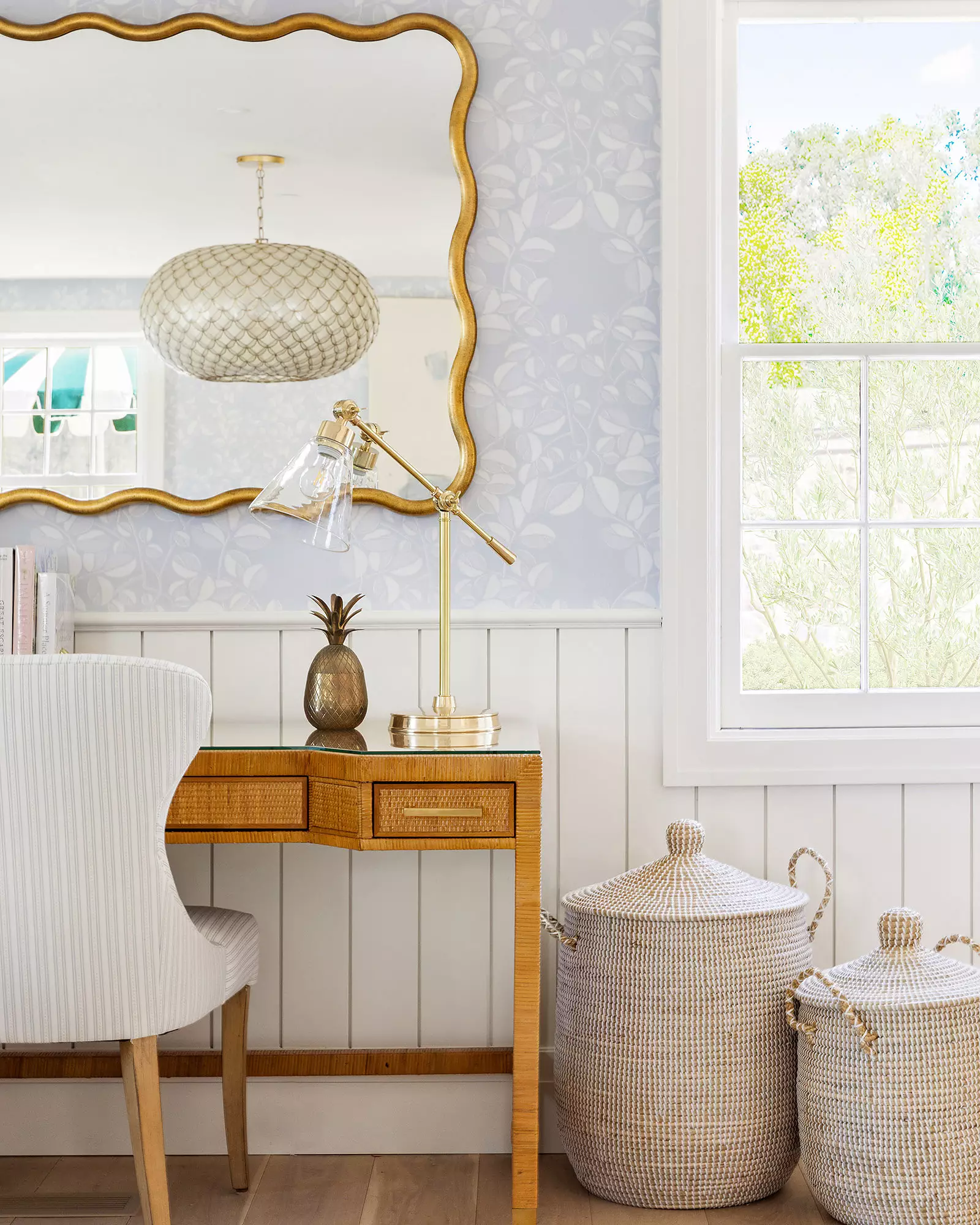 Serena & Lily La Jolla handwoven lidded rattan and seagrass storage basket sitting in a beautifully styled home interior corner.
