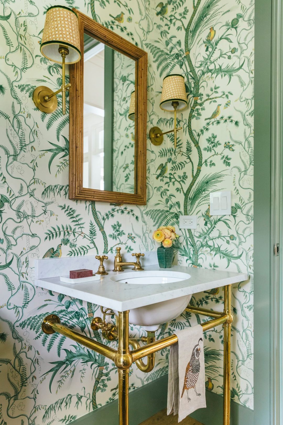 Traditional powder room featuring historic Brunschwig and Fils Bird and Thistle wallpaper contrasted by clean white porcelain and a vibrant green trim paint.