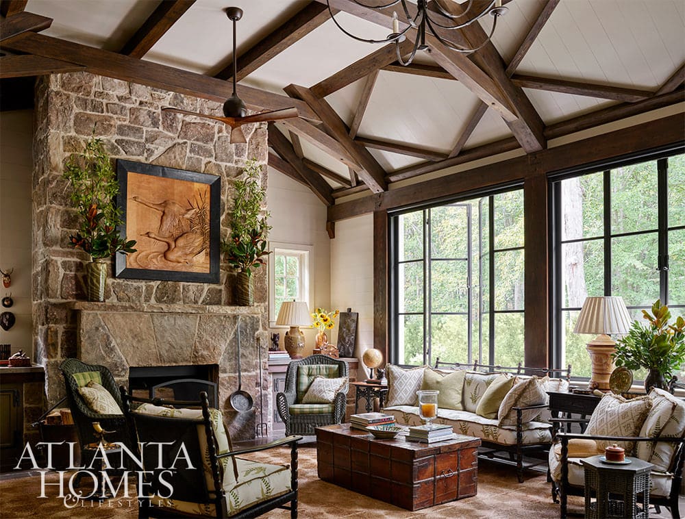 Beautiful living room in Dutch Colonial home with stone fireplace and wood beams 